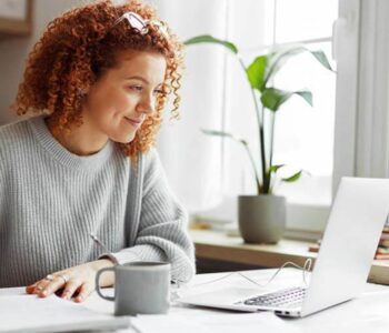 A Woman using a laptop searching how to join a credit union