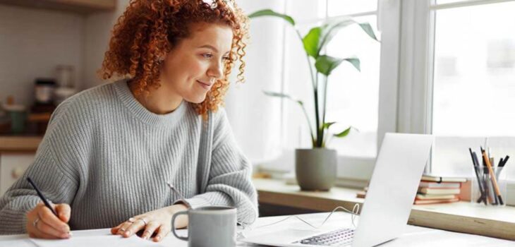 A Woman using a laptop searching how to join a credit union